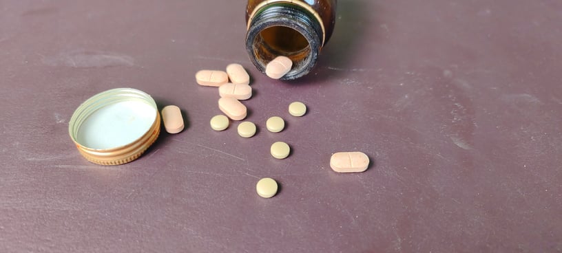 pills and bottle on brown background. Pills on a colored background top view medicine treatment illness